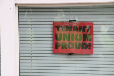 A sign in the window says: Tenant Union Proud!