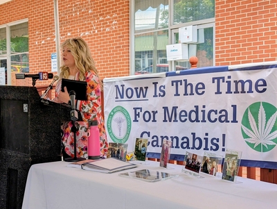 a patient speaks about the benefits of medical cannabis on a microphone