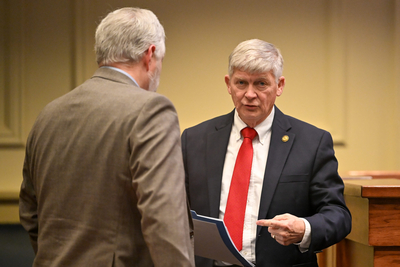 Two men in suits talking.