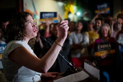 A woman speaking into a microphone.