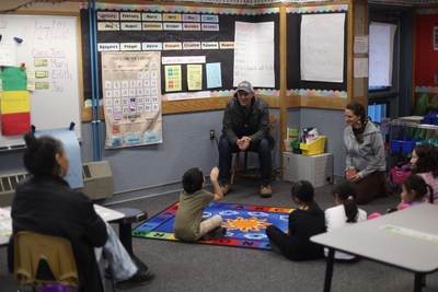 Hill speaks with children at a classroom in Kokhanok this week. (Nathaniel Herz/Anchorage Press)