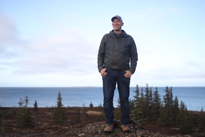 Hill stands above the shore of Iliamna Lake in the village of Kokhanok, where he grew up. (Nathaniel Herz/Anchorage Press)