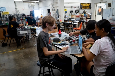 A robotics team at work at Nānākuli High &amp; Intermediate School June 29, 2026. From right, are: Khailey Buentipo, Ethan Faeldonea, and Seiji Nakata. (Craig Fujii/Civil Beat/2026)