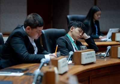 A student delegate, center, sleeps during a session learning the legislative process at the capitol building.