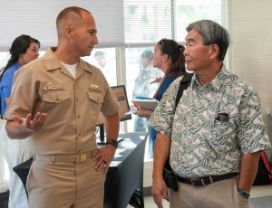 Lt. Cmdr. Matthew Lundin,  assistant deputy for contracting for environment and remediation, Navy Closure Task Force-Red Hill (NCTF-RH), speaks with Ernie Lau, manager and chief engineer, Honolulu Board of Water Supply, during the  quarterly NCTF-RH open house, held at the Hokulani Community Center in Honolulu, May 21, 2025.  NCTF-RH hosted the event for members of the community to learn more about current environmental efforts at the Red Hill Bulk Fuel Storage Facility (RHBFSF) as well as long-term intenti