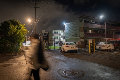 A woman is blurred as she walks through a Kalihi neighborhood August 14, 2026. Emerson Butay was found dead nearby. (Craig Fujii/Civil Beat/2026)
