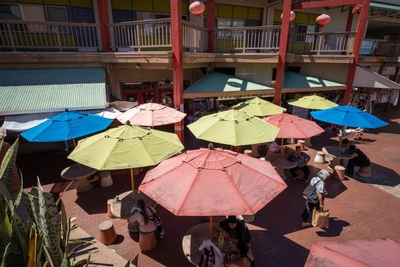 Umbrellas cast welcome shade at Maunakea Marketplace August 12, 2026. Aemarie Bracks died close by. (Craig Fujii/Civil Beat/2026)