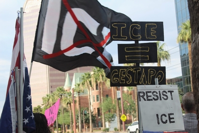 A poster equates ICE agents to Gestapo, the secret police of Nazi Germany, during a protest in Phoenix, Ariz. on July 17, 2025. The agency has faced increasing public disapproval in response to increased raids and and a spike in due process violations. (Photo by Gloria Rebecca Gomez/Arizona Mirror)