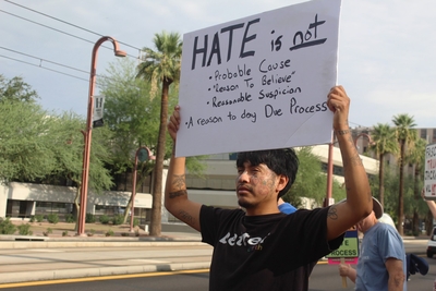 Angel Mendoza, 33, criticizes the Trump administration’s mass deportation agenda in Phoenix, Ariz. on July 17, 2025. Mendoza is the son of immigrants, and he worries about the safety of his family as ICE ramps up their immigration enforcement activity. (Photo by Gloria Rebecca Gomez/Arizona Mirror)