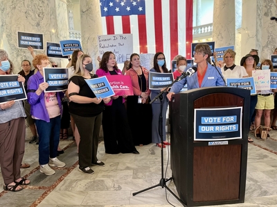 Sen. Melissa Wintrow speaking in front of a crowd