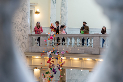 The Rev. Sara LaWall drops hearts down the rotunda of the Idaho State Capitol Building. Protestors on April 2, 2024, dropped 48,000 handmade hearts — meant to represent LGBTQ Idahoans — in protest of anti-LGBTQ legislation.