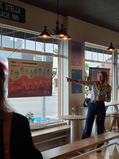 Jen Jackson Quintano presents the "Worth of a Woman" exhibit, which explores a range of women's health care issues, at a coffee shop in downtown Sandpoint, Idaho.