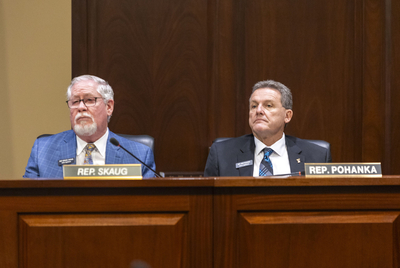 Idaho state Reps. Bruce Skaug, R-Nampa, and Mike Pohanka, R-Jerome, listen to proceedings during the House State Affairs Committee