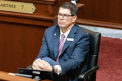 Sen. Kevin Cook, R-Idaho Falls, listens to proceedings on the Senate floor at the Idaho Capitol