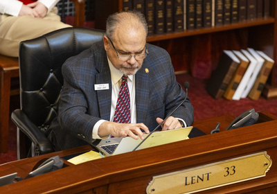Sen. Dave Lent, R-Idaho Falls, works from the Senate floor