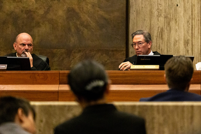 Idaho Supreme Court Justice Gregory Moeller asks a question during a lawsuit hearing. He is seated on his dais, next to Chief Justice G. Richard Bevan.