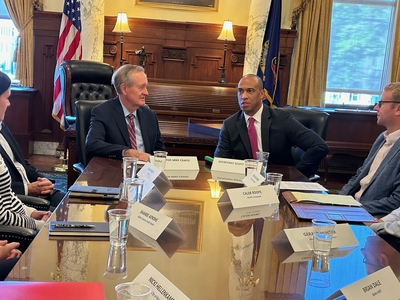 Senator Mike Crapo and Housing and Urban Development Secretary Scott Turner talk at a meeting table in the Idaho State Capitol