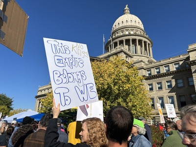 A protestor holds up a sign during the No Kings 2.0 rally held Oct. 18, 2025, at the Idaho Capitol in Boise