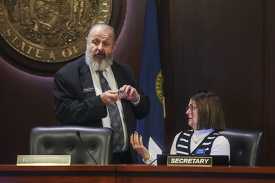Rep. Dale Hawkins, R-Fernwood chats with the House Education Committee's secretary Amy Bengtzen