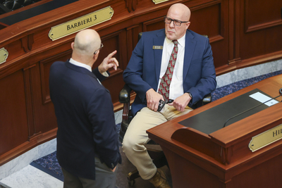 Rep. Ted Hill, R-Eagle, chats with a colleague on Idaho House of Representatives floor