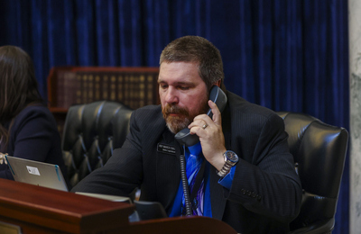 Rep. Marco Erickson, R-Idaho Falls, makes a phone call from the House floor