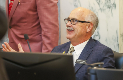 Rep. Rod Furniss, R-Rigby, talks with colleagues on the Joint Finance-Appropriations Committee