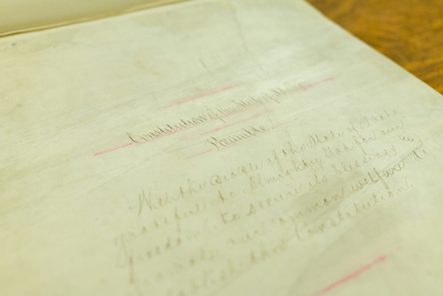 The original copy of the Idaho state Constitution, with bleeding red ink and tattered pages.