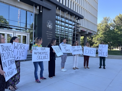Supporters of the ACLU's lawsuit against Idaho's criminal transgender bathroom ban hold signs outside the federal courthouse.