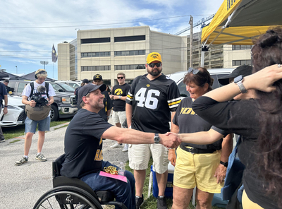 Iowa, national politicians court voters at CyHawk tailgates