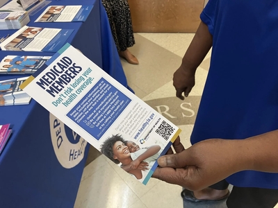 Chenita LeBlanc, a program manager with DePaul Community Health Center, holds a flyer for Louisiana Medicaid members
