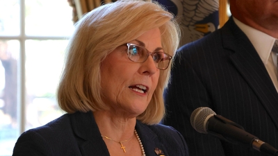 Nancy Landry speaking at podium