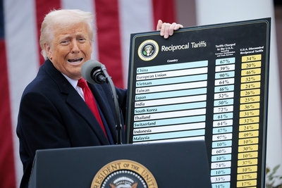 Trump holds up a chart while speaking during an event in the Rose Garden at the White House on April 2, 2025. Touting the event as “Liberation Day,” Trump announced additional tariffs targeting goods imported to the U.S. (Photo by Chip Somodevilla/Getty Images)