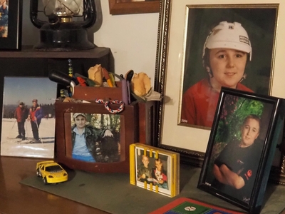 A collection of framed photographs of a young boy.