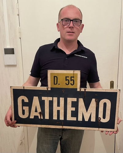 Christophe Clement is holding a WWII-era sign for the French town of Gathemo. (Courtesy of Christophe Clement)