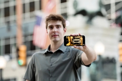 Phil Rishel holds his phone, which shows footage he took (Photo courtesy of FIRE)