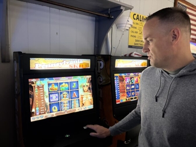 Michael Barley demonstrates how to play skill games at the Highspire VFW in Dauphin County. (Photo by Hayley O'Brien/WITF)