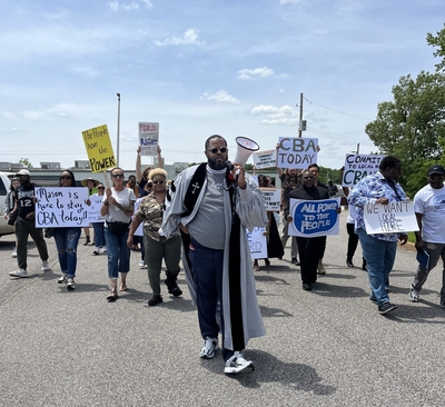 Members of BlueOval Good Neighbors, a coalition of residents from Haywood, Tipton, Lauderdale, Shelby, and Fayette counties, march to BlueOval SK's Arlington, Tenn. office on May 6, 2025. (Photo: BlueOval Good Neighbors/Tennessee for All)