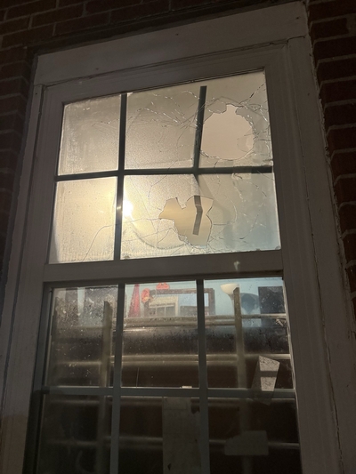 A broken window with holes in it.