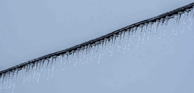 Icicles hang from a power line.