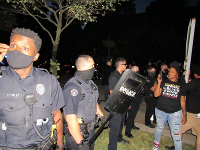 Wauwatosa officers confront protesters in the days after the incident at Mensah's house. (Photo by Isiah Holmes)