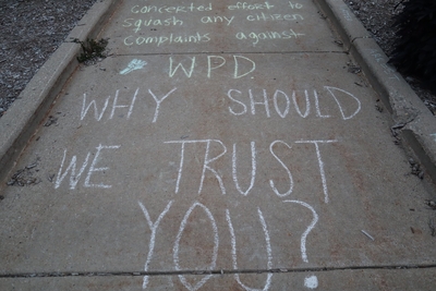Protesters marked the ground outside the Wauwatosa City Hall with chalk displaying a variety of messages. (Photo by Isiah Holmes)