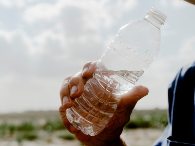 Ed Joungmann, a Nueces County farmer who is on the the soil conservation board, holds a bottle of water from his well in Nueces County.