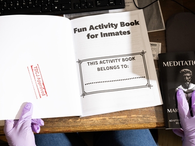 Page stamps books for approval after scanning them for possible contraband.