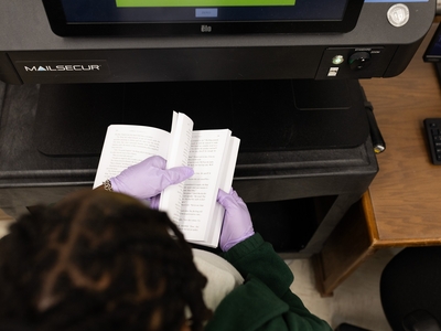 SLIDESHOW: TDCJ administrative assistant Alexis Page scans books in the mail room at the Wynne Unit in Huntsville to look for possible contraband.