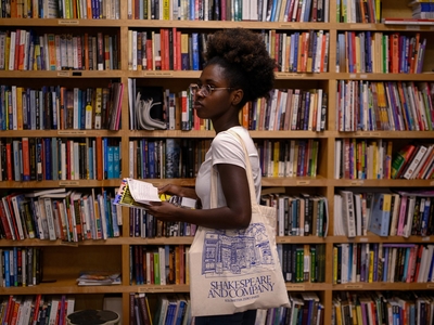 Leslie Gnokoro, 22, of Austin, looks through a library of approved books at Inside Project Books at the Vesper in East Austin on May 21.