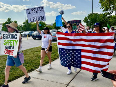 Protesters use CWS as backdrop to decry Trump immigration policies, raids