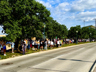 Protesters use CWS as backdrop to decry Trump immigration policies, raids