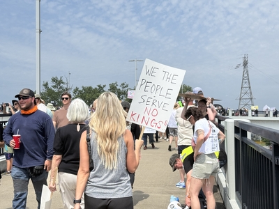 Protesters march across Little Rock's Veteran's Memorial Bridge on Saturday, June 14, 2025, as part of a national "No Kings" demonstration against Trump administration policies and actions. (Ainsley Platt/Arkansas Advocate)