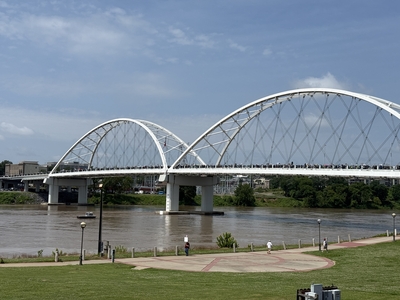 A wide shot of Veteran's Memorial Bridge as protesters march back across as part of the No Kings protest in Little Rock on Saturday, June 14, 2025.