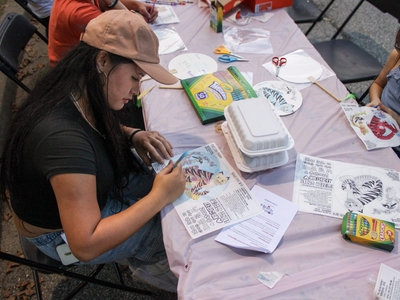 A person at a festival activity table